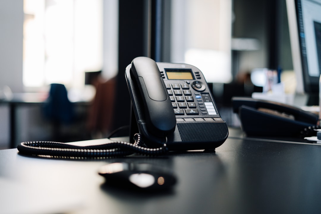 Home Modern VoIP desk phone in professional office setting representing cloud PBX systems