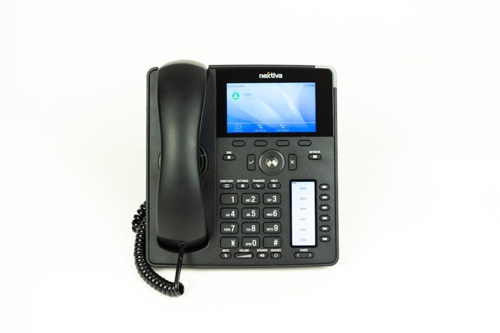 Modern VoIP business phone with display showing subscriber features and call management interface