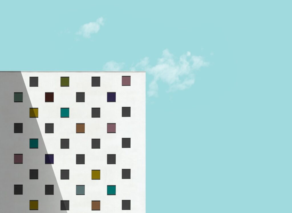 Modern apartment building with separate units sharing common infrastructure, illustrating multi-tenant PBX architecture concept
