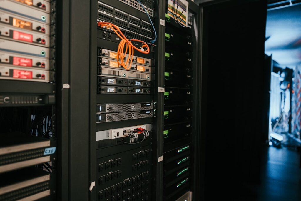 Server rack infrastructure in data center representing cloud telephony and Class 5 softswitch deployment environment. Photo by Taylor Vick on Unsplash